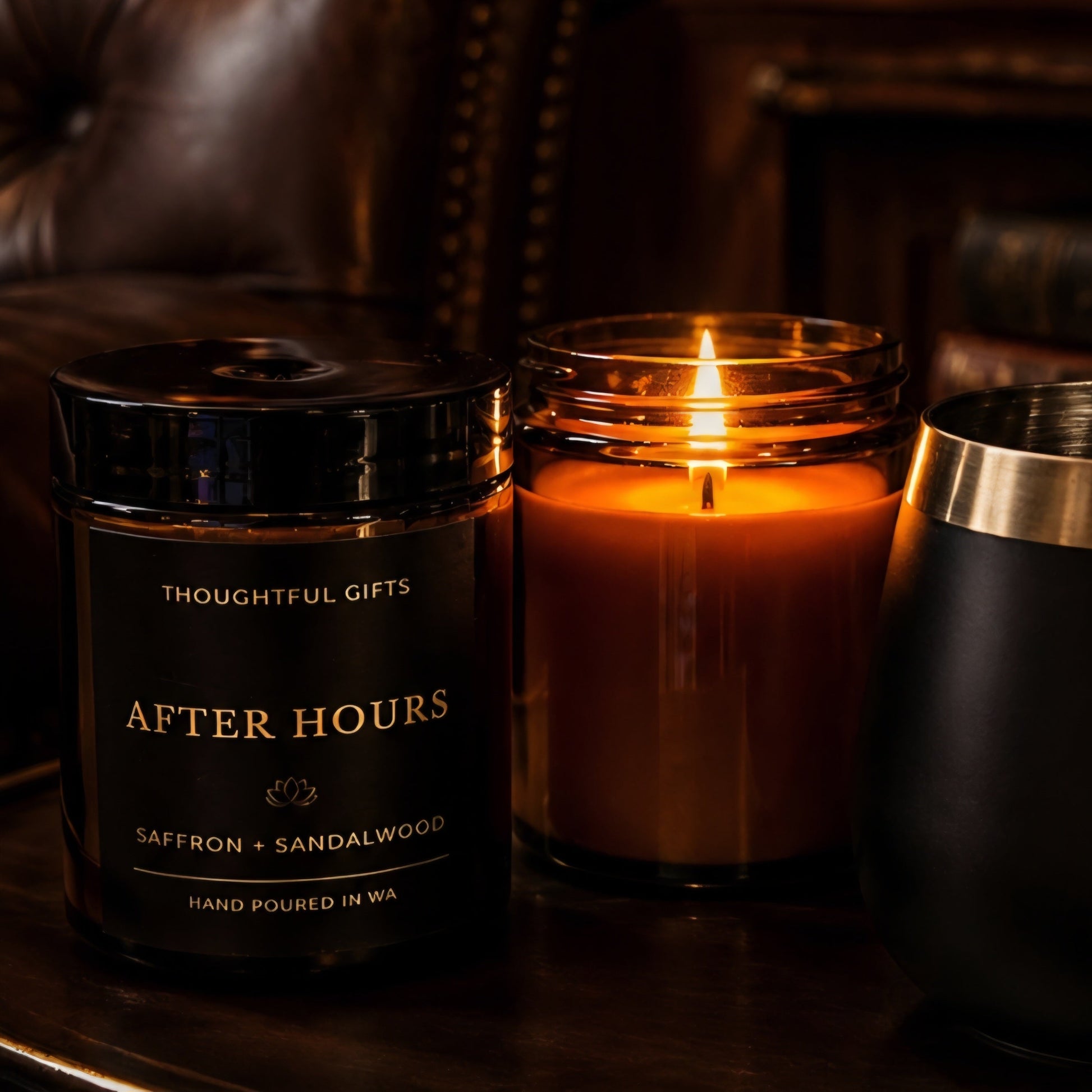 Candle labeled 'After Hours' with a lit candle on a wooden surface, surrounded by a cozy interior.