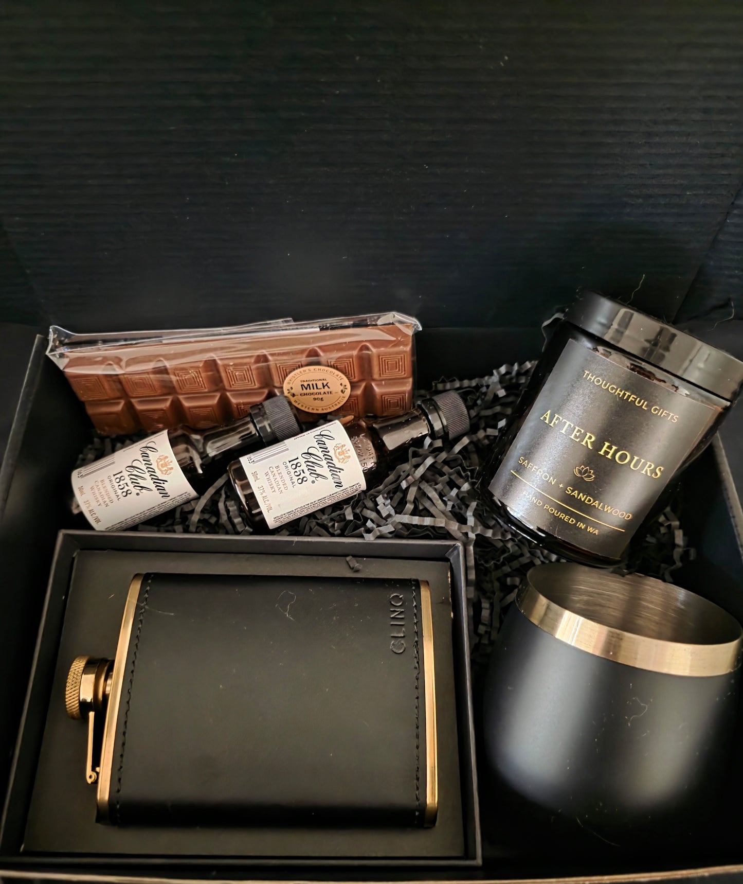 Gift set with a black hip flask, candles, Whisky