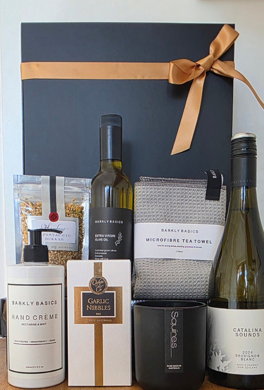 Luxury gourmet gift hamper with wine, self care, candle, sweet treets.